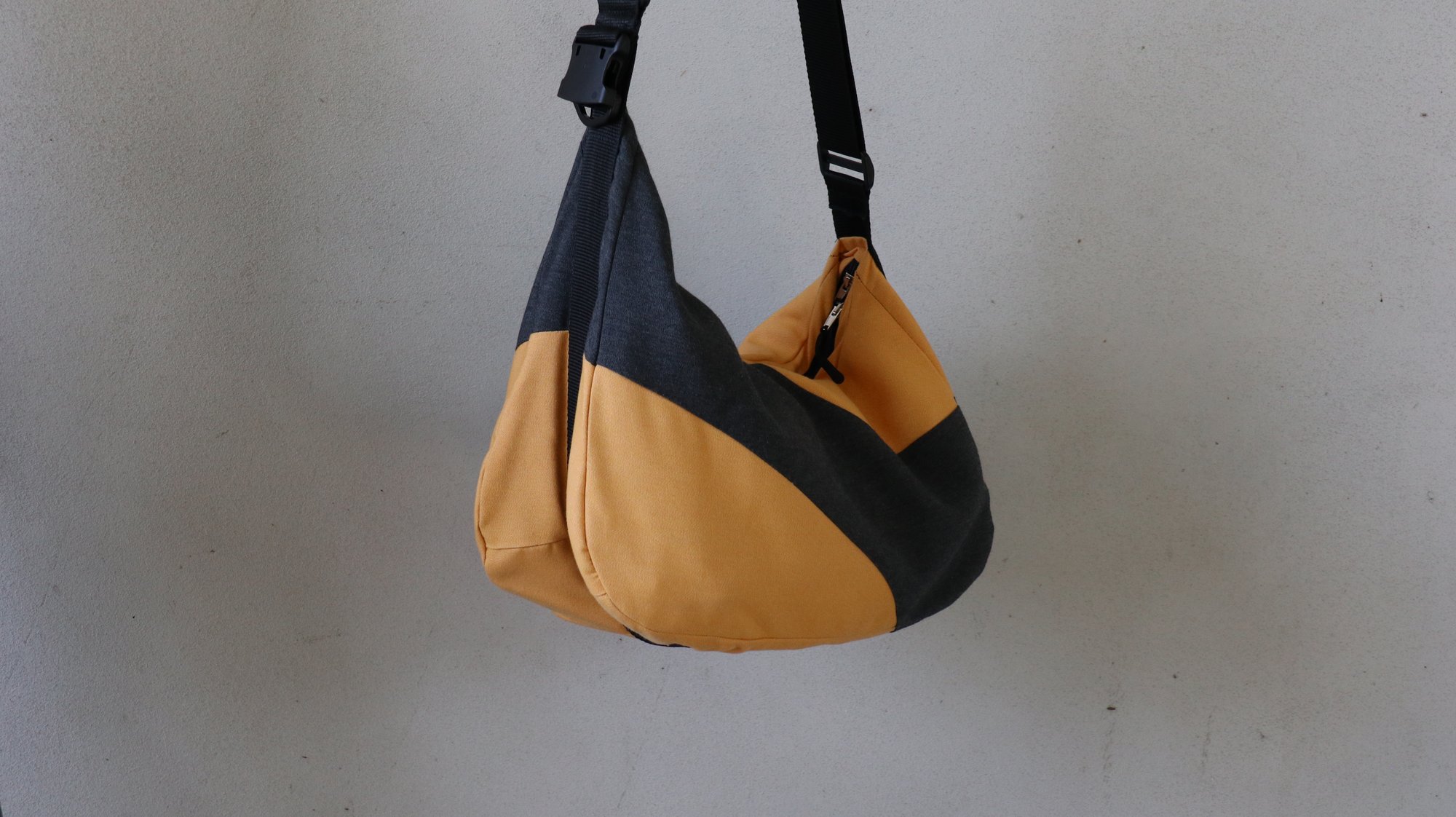 SHFT bag product shot, showing the colourblock fabric, strap buckle and zipper
